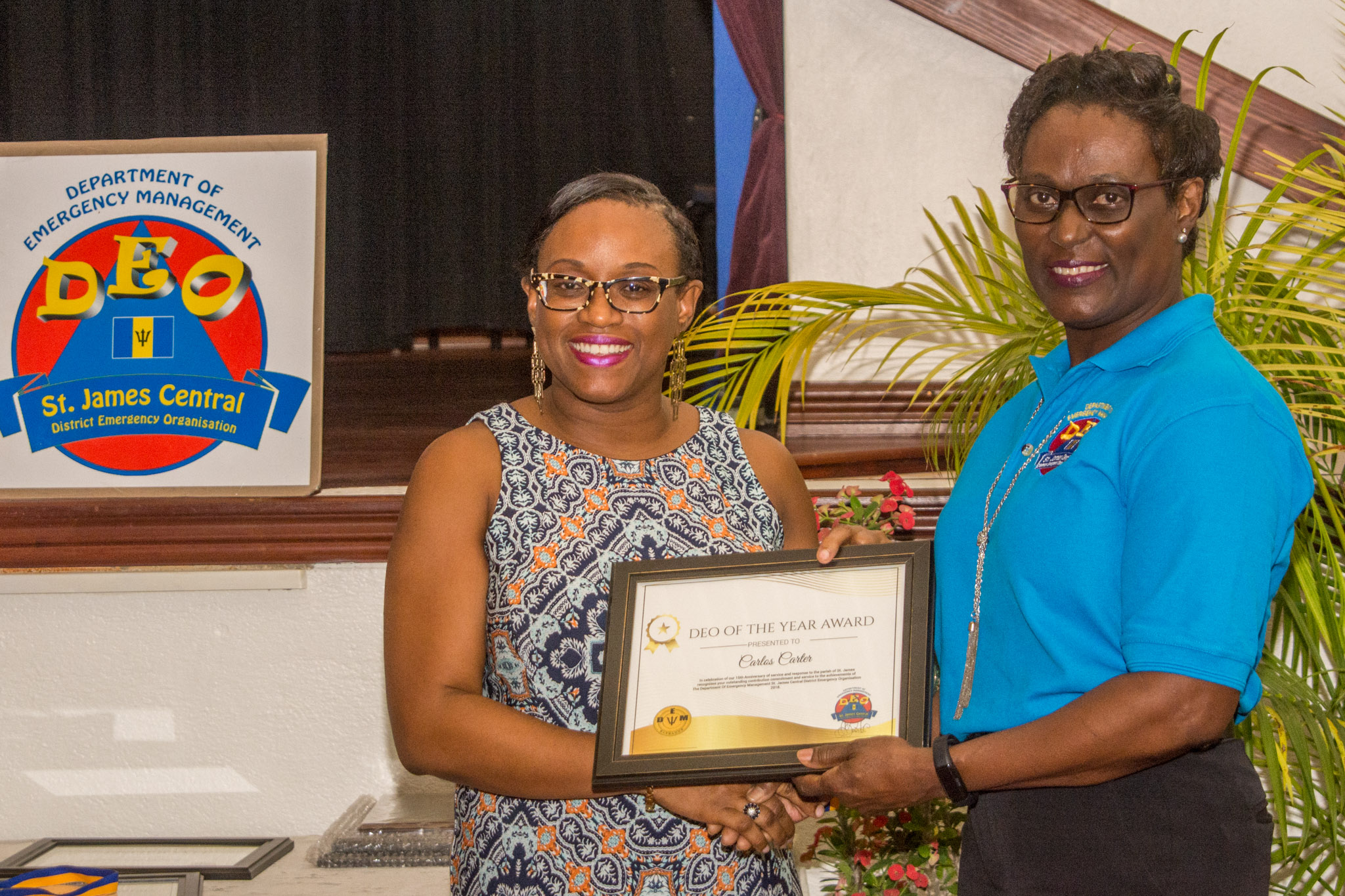 Alicia Sobers receives DEO of the Year Award on behalf of Carlos Carter