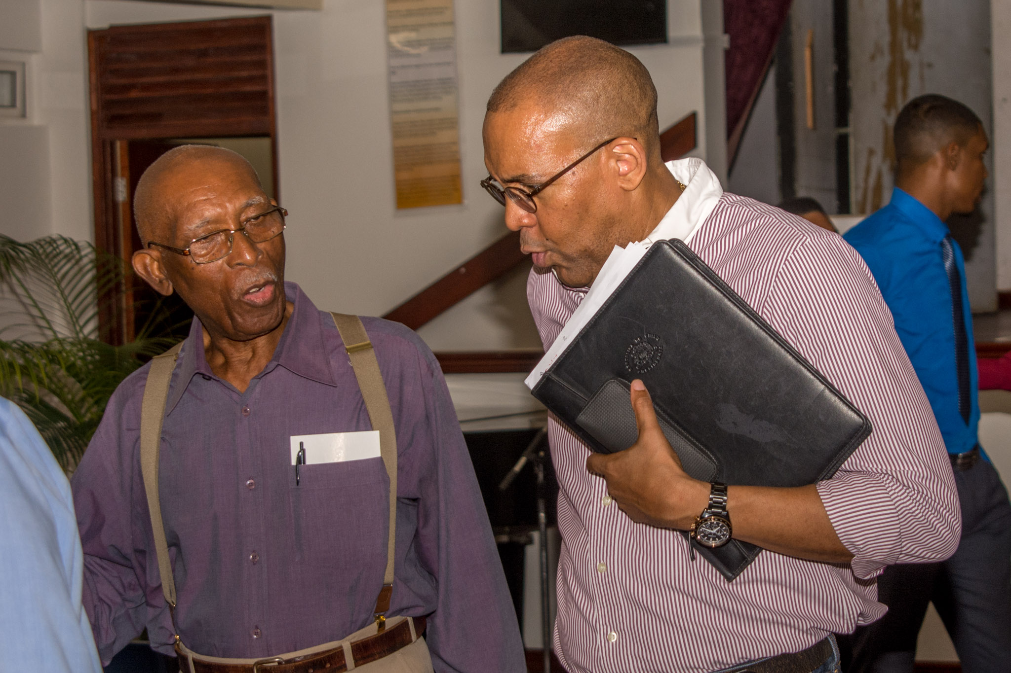 Hon. Kerrie Symmonds speaking with founding member Mervyn Cumberbatch