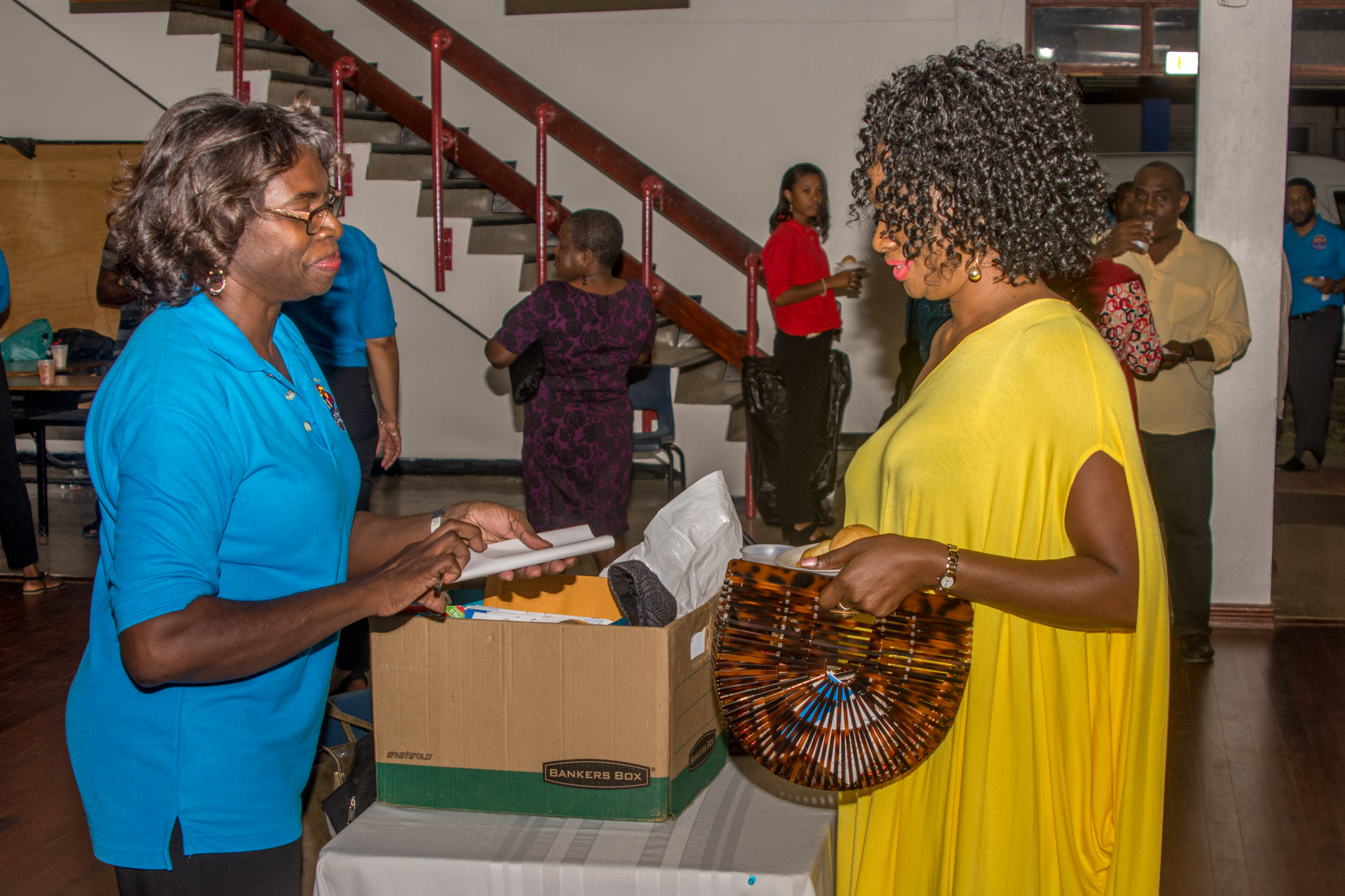 Secretary Cynthia Brooks collects an application form